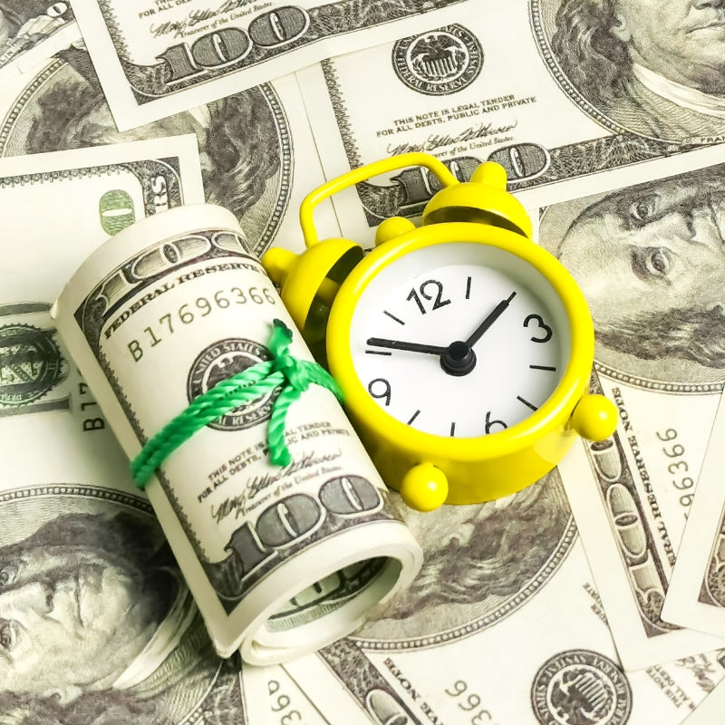 bundles of hundred-dollar bills and a yellow stopwatch