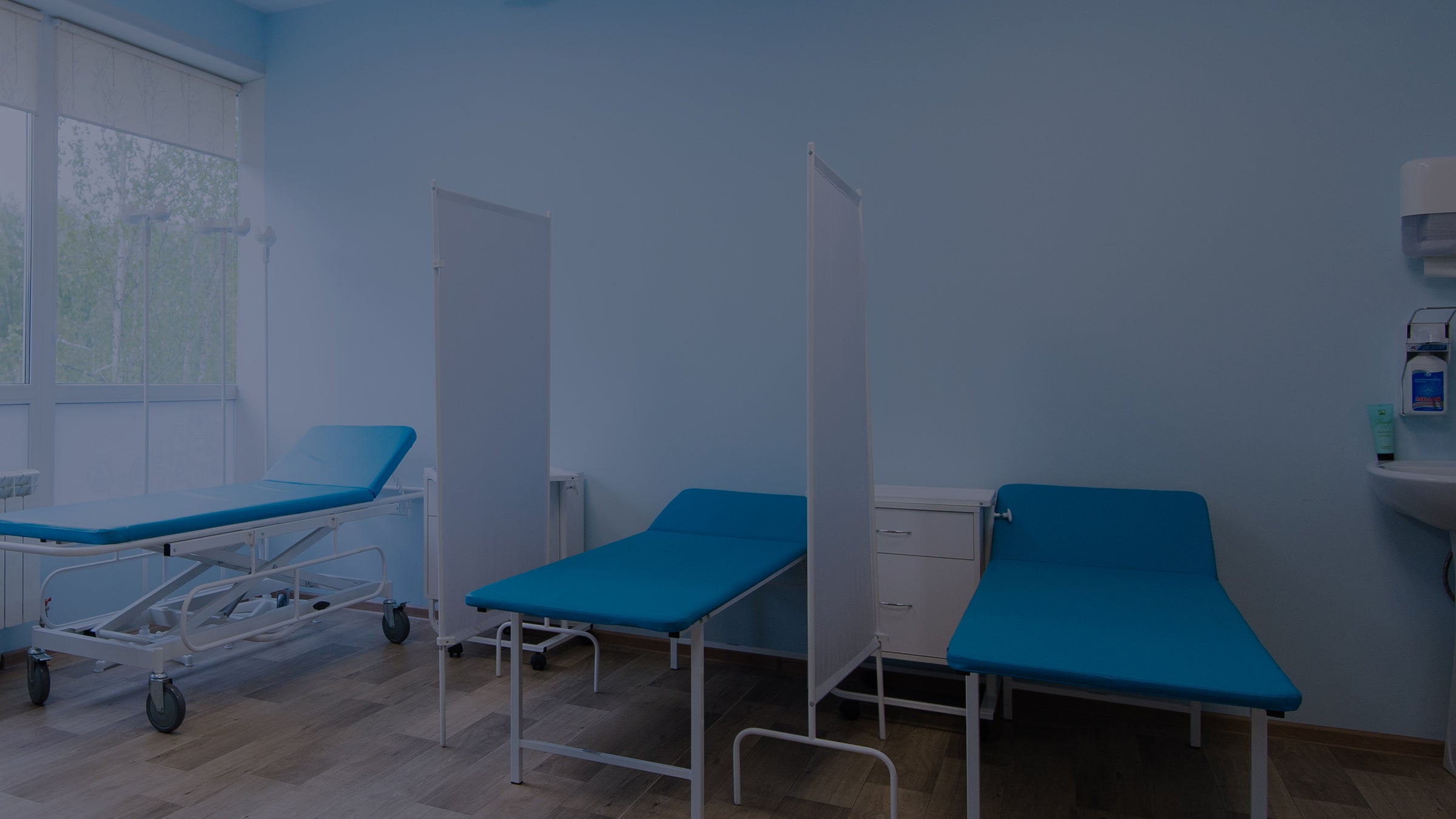 Healthcare beds in blue hospital room