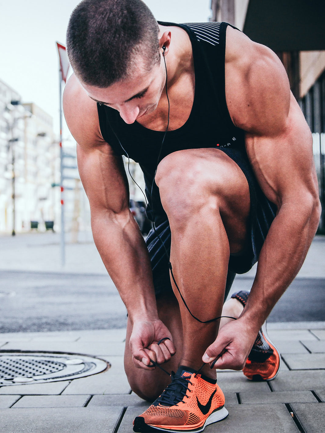 Athlete tying his shoes preparing for a workout