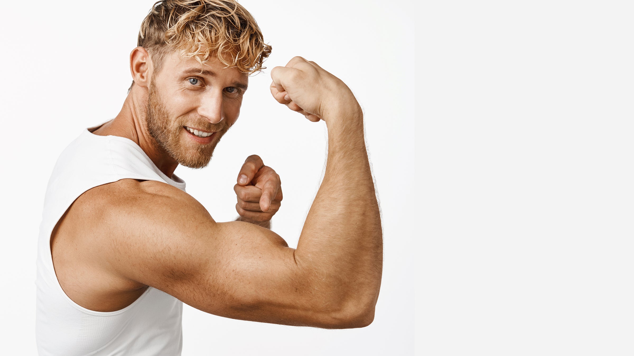 Strong blonde man pointing at bulging bicep muscle